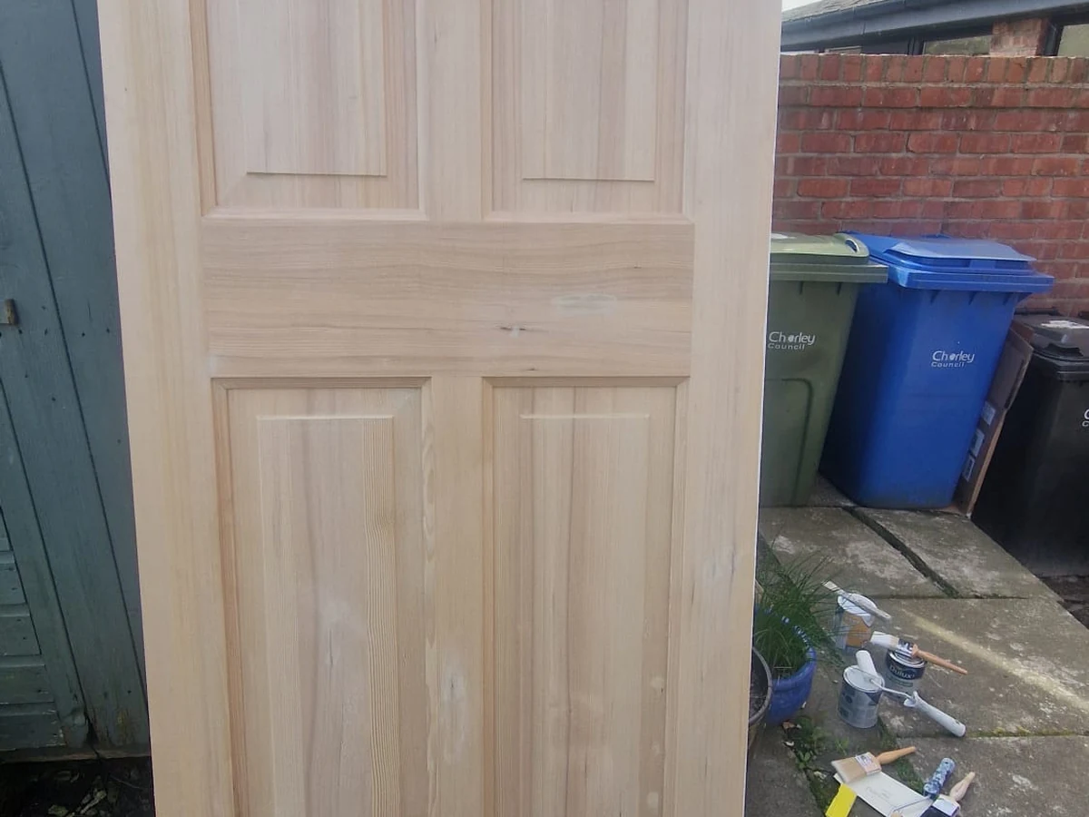 Door painting in progress — wood stain application on a door in Preston by Rose Decor
