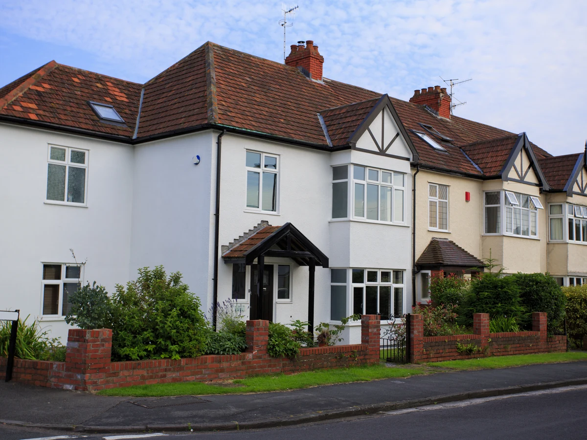Exterior house painting — 1930s semi-detached with white render and mock Tudor detailing in Preston
