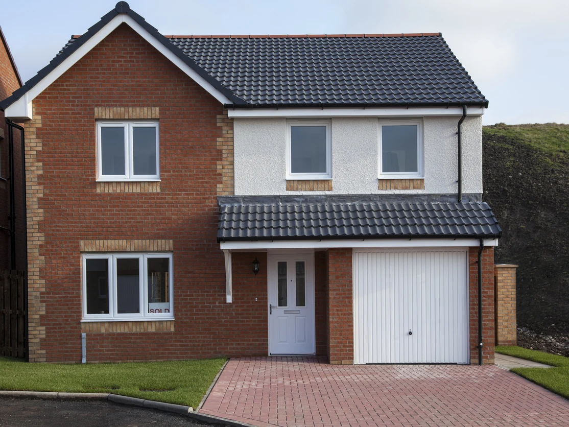 Exterior house painting — detached with white render, red brick lower section and block-paved driveway in Preston