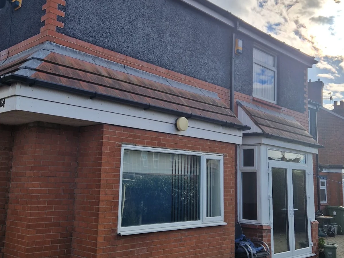 Exterior house painting — grey fascia finish with brick elevation in Preston by Rose Decor