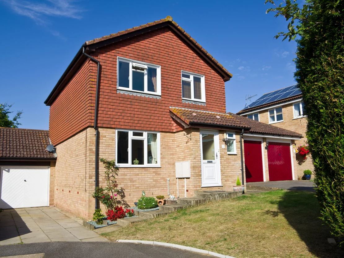 Garage door painting in Preston by Rose Decor — suburban detached with red brick and red garage door