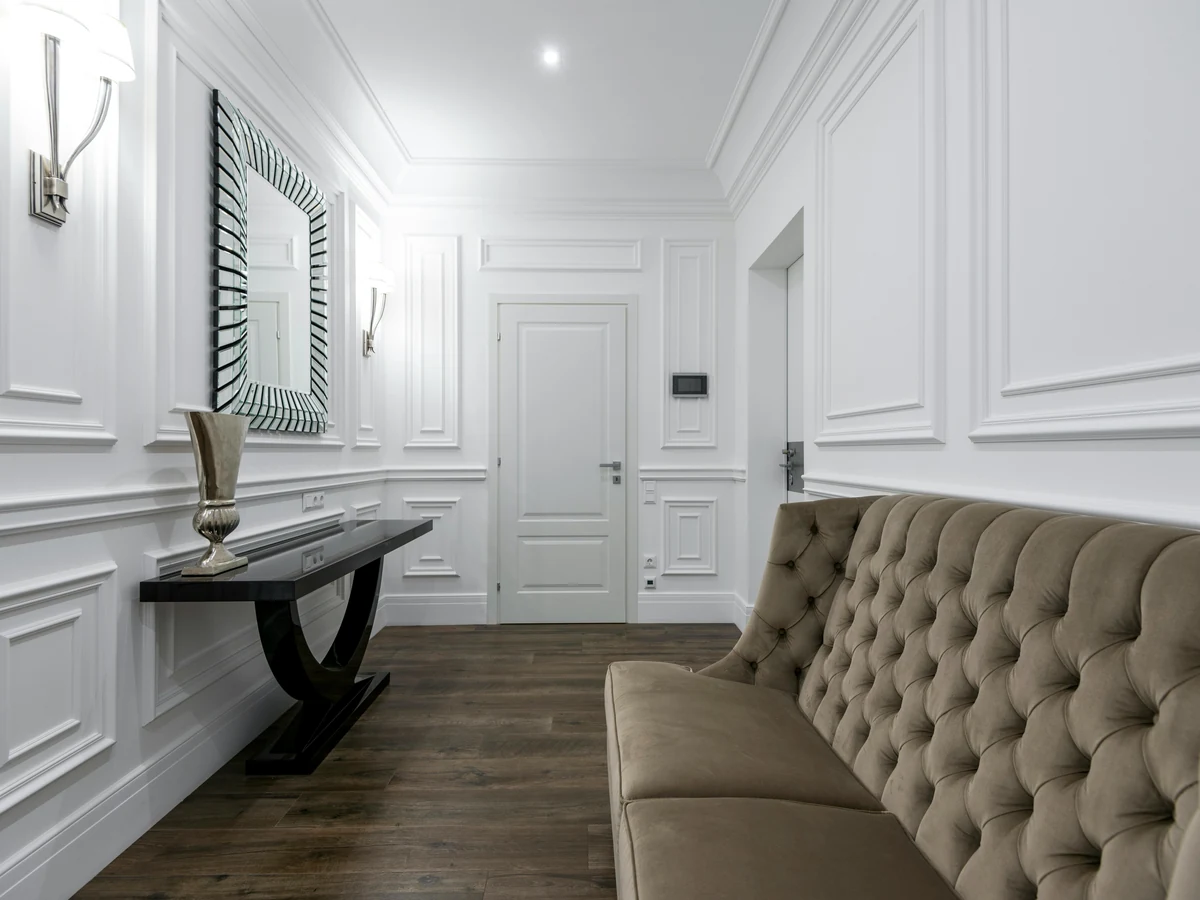 White panelled walls with raised moulding in a painted hallway in Preston by Rose Decor
