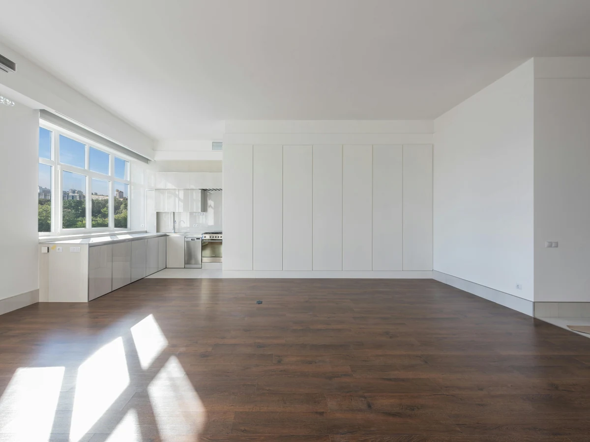 White walls with floor-to-ceiling built-in cupboard panels in an open room, Preston home office woodwork by Rose Decor