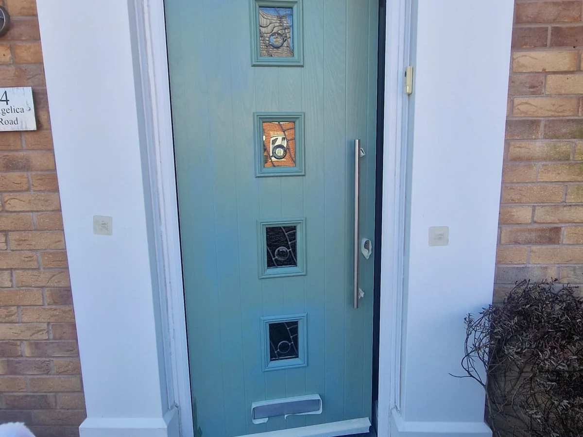 Residential door painting — teal front entrance on a brick house in Preston by Rose Decor