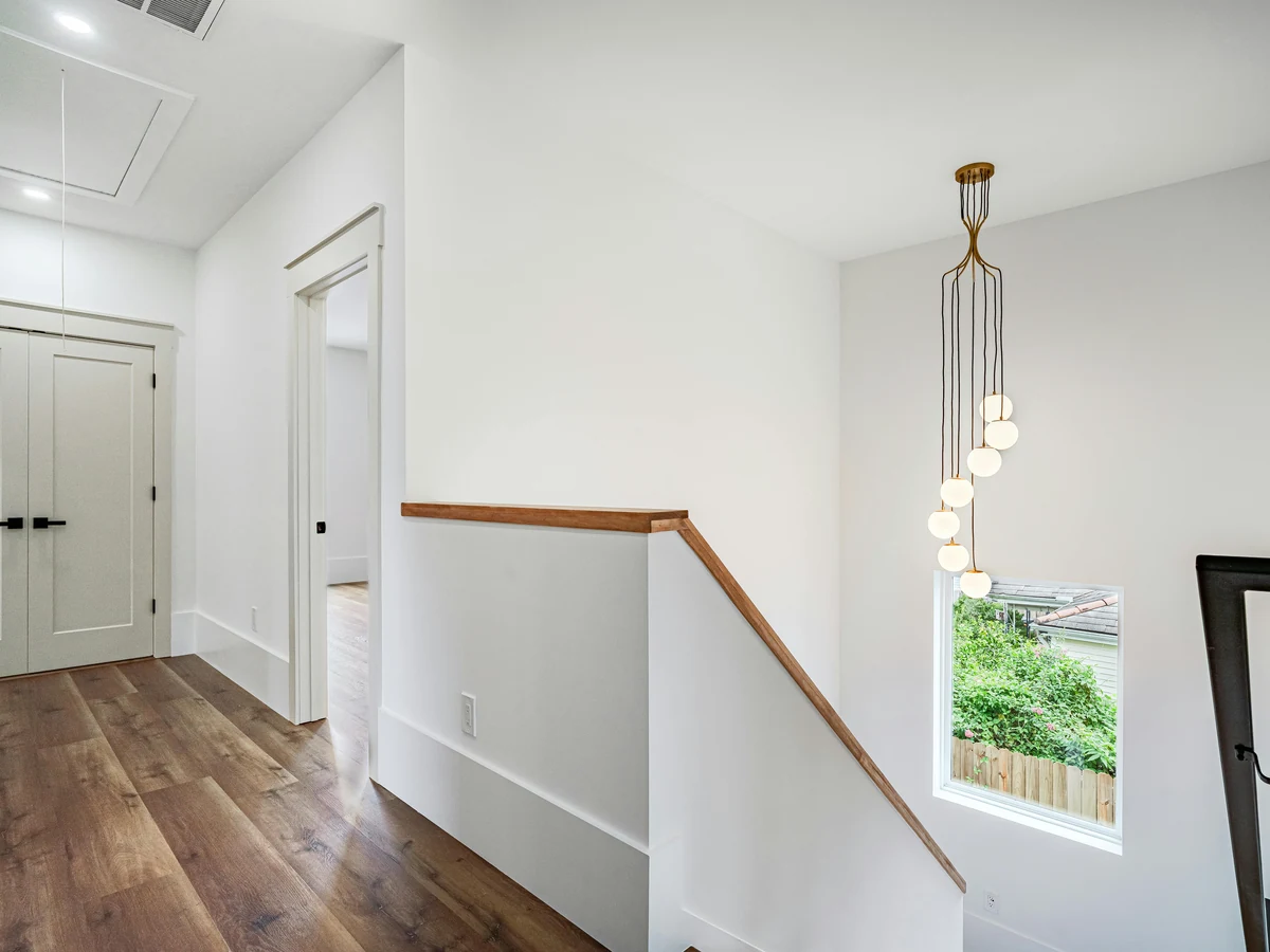 Wood handrail and white skirting boards on a painted staircase in Preston by Rose Decor, specialist wood painters